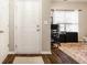 Entryway with hardwood floors, a white door, and natural light streaming through the office window at 17183 Petersfield Ln, Westfield, IN 46074