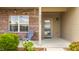 Inviting front porch featuring brick accents, vinyl siding, and outdoor seating at 17183 Petersfield Ln, Westfield, IN 46074