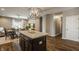 Open-concept kitchen with an island and bar seating that flows into the dining and living areas at 17183 Petersfield Ln, Westfield, IN 46074