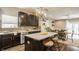 Stylish kitchen featuring dark cabinetry, granite countertops, stainless steel appliances, and an island with barstool seating at 17183 Petersfield Ln, Westfield, IN 46074
