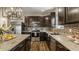Well-equipped kitchen with stainless steel appliances, dark cabinets and granite countertops at 17183 Petersfield Ln, Westfield, IN 46074