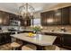Stylish kitchen featuring dark cabinetry, granite countertops, stainless steel appliances, and an island with barstool seating at 17183 Petersfield Ln, Westfield, IN 46074