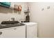 Laundry room with white front load washer and dryer and wire shelving at 17183 Petersfield Ln, Westfield, IN 46074