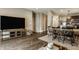 Open concept living room and dining area with dark wood floors and a large screen television at 17183 Petersfield Ln, Westfield, IN 46074
