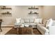 Comfortable living room with a large sectional sofa, wood floors and decorative shelving at 17183 Petersfield Ln, Westfield, IN 46074