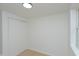 Bedroom with light gray walls, hardwood flooring, a double closet, and a window at 1740 Haynes Ave, Indianapolis, IN 46240