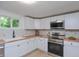 Modern kitchen featuring stainless steel appliances, white cabinetry, and stylish butcher block countertops at 1740 Haynes Ave, Indianapolis, IN 46240