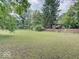 Expansive backyard with green lawn and mature trees creating a private outdoor space at 1908 W Northgate St, Indianapolis, IN 46228