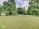 Expansive backyard with a large lawn and mature trees creating a peaceful environment at 1908 W Northgate St, Indianapolis, IN 46228