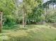 Lush backyard with mature trees and green grass, offering a serene outdoor setting at 1908 W Northgate St, Indianapolis, IN 46228