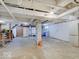Spacious unfinished basement area with exposed ceiling, concrete floor, and utility connections at 1908 W Northgate St, Indianapolis, IN 46228