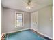 Bedroom featuring a ceiling fan, a window with view to outdoors, and light gray walls at 1908 W Northgate St, Indianapolis, IN 46228