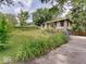 Landscaped yard surrounds this charming home; driveway and garage on right side of home at 1908 W Northgate St, Indianapolis, IN 46228
