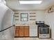 Cozy kitchen featuring stainless steel appliances and floating wooden shelves at 1908 W Northgate St, Indianapolis, IN 46228