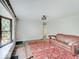 Living room featuring original floors, vintage rug, view of front yard and front door at 1908 W Northgate St, Indianapolis, IN 46228