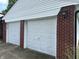 Two car garage with white doors and brick siding at 2211 Rosedale Dr, Indianapolis, IN 46227