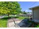 The backyard features a mature tree and an inviting patio seating area at 238 S 5Th Ave, Beech Grove, IN 46107