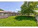 A spacious backyard offers a mature tree, providing ample shade and a peaceful setting at 238 S 5Th Ave, Beech Grove, IN 46107