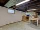 This basement has white painted walls and wooden support beams with a utility window at 238 S 5Th Ave, Beech Grove, IN 46107