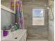 This bright bathroom features grey tiled walls, updated fixtures and a large mirror at 238 S 5Th Ave, Beech Grove, IN 46107