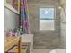 This bathroom features gray tiled walls, updated fixtures and natural light at 238 S 5Th Ave, Beech Grove, IN 46107