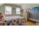 Comfortable bedroom features dual windows, light-colored walls, and hardwood floors at 238 S 5Th Ave, Beech Grove, IN 46107