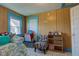 Inviting bedroom features a daybed, storage solutions, and classic wood paneling at 238 S 5Th Ave, Beech Grove, IN 46107