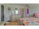 Bedroom with hardwood floors, colorful bedding, dresser, and a serene atmosphere at 238 S 5Th Ave, Beech Grove, IN 46107