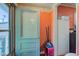 This mudroom-style entryway features beadboard, vintage doors, and a convenient storage setup at 238 S 5Th Ave, Beech Grove, IN 46107