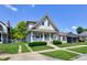 Inviting two-story home with a charming front porch, manicured lawn, and classic architectural details at 238 S 5Th Ave, Beech Grove, IN 46107