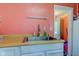 Cozy kitchen view showcases a stainless steel sink, wood countertops, and adjacent doorway at 238 S 5Th Ave, Beech Grove, IN 46107