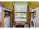 Functional laundry area with a washer, dryer, and natural light from the window at 238 S 5Th Ave, Beech Grove, IN 46107
