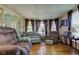 Spacious living room featuring hardwood floors, comfortable seating, and large windows for natural light at 238 S 5Th Ave, Beech Grove, IN 46107