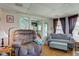 Cozy living room with hardwood floors, a plush recliner, and large windows letting in natural light at 238 S 5Th Ave, Beech Grove, IN 46107