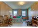 Cozy living room with wood paneling, comfortable seating, and natural light from two windows at 238 S 5Th Ave, Beech Grove, IN 46107