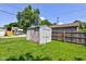 The backyard features a storage shed with a mature tree and lush green grass at 238 S 5Th Ave, Beech Grove, IN 46107