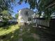 View of home's backyard showcasing a grassy yard, shade trees, and an outbuilding at 2509 S New Jersey St, Indianapolis, IN 46225