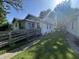 Quaint home with a ramp that leads up to the front porch and mature trees in a peaceful neighborhood at 2509 S New Jersey St, Indianapolis, IN 46225