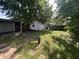 View of home's outbuilding situated in a shady backyard with stepping stone pavers at 2509 S New Jersey St, Indianapolis, IN 46225