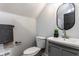 Bathroom features a vanity, toilet, and towel rack against gray walls at 2954 N Washington Blvd, Indianapolis, IN 46205
