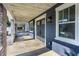 Inviting covered front porch with stone pillars, a stylish front door, and natural wood ceiling at 2954 N Washington Blvd, Indianapolis, IN 46205