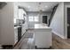 Open kitchen with white cabinets, an island with seating, and modern pendant lighting at 2954 N Washington Blvd, Indianapolis, IN 46205