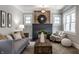 Bright living room with a brick fireplace, ample seating, and a decorative rug at 2954 N Washington Blvd, Indianapolis, IN 46205
