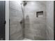 Modern shower featuring gray tiled walls, rainfall shower head, and a recessed shelf at 2954 N Washington Blvd, Indianapolis, IN 46205