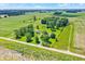 Aerial view displays this property's homes, outbuildings, and sprawling lawn surrounded by farmland at 3001 W 226Th St, Sheridan, IN 46069