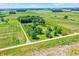 A serene aerial view of a countryside home surrounded by green fields and mature trees at 3001 W 226Th St, Sheridan, IN 46069