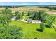 Aerial view shows a home featuring a tree-lined perimeter, with outbuildings, and open lawn spaces at 3001 W 226Th St, Sheridan, IN 46069