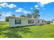 Single story home featuring green shutters and a small porch, with a lush green lawn that enhances the property's appeal at 3001 W 226Th St, Sheridan, IN 46069