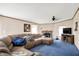 Inviting living room featuring a plush sectional, stone fireplace, and comfortable seating for relaxing and entertaining guests at 3001 W 226Th St, Sheridan, IN 46069