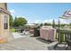 Spacious backyard deck features a Traeger grill, seating, and views of the manicured lawn and lake at 301 Cobblesprings Ct, Avon, IN 46123